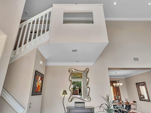 interior space featuring a chandelier, recessed lighting, visible vents, and crown molding