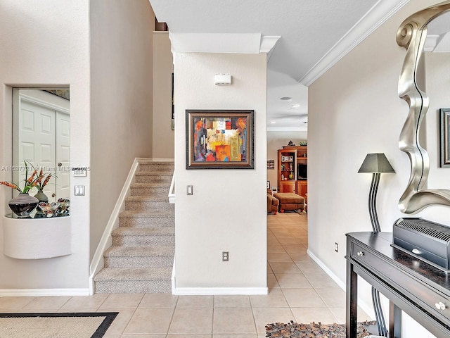 stairway featuring ornamental molding, tile patterned flooring, and baseboards