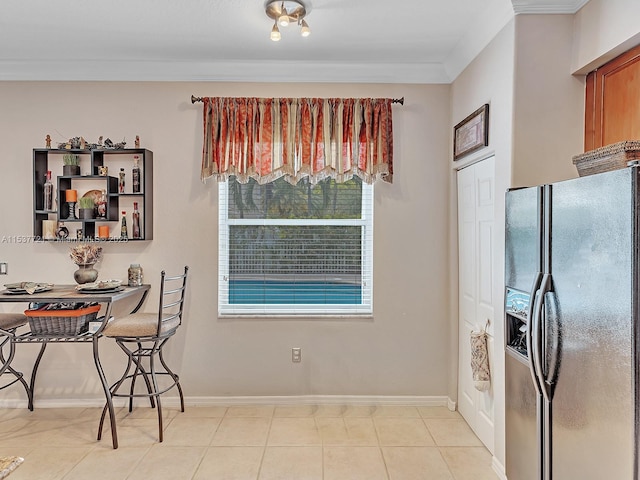 dining space with light tile patterned floors, baseboards, and ornamental molding