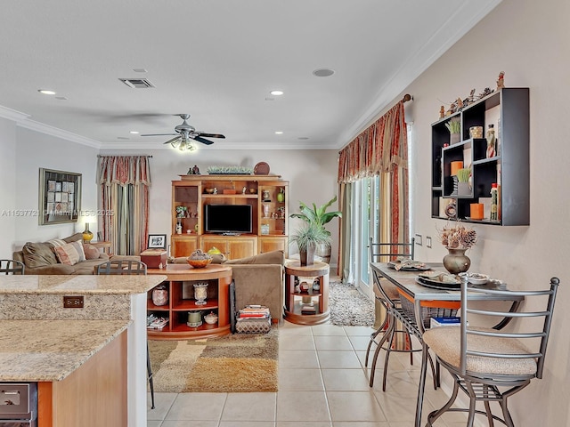 kitchen with visible vents, open floor plan, light stone countertops, crown molding, and light tile patterned flooring