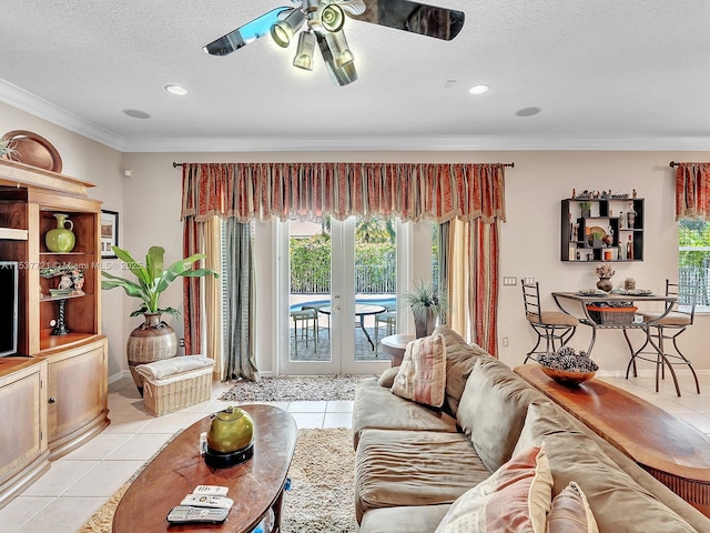 living area with light tile patterned floors, crown molding, a textured ceiling, and french doors