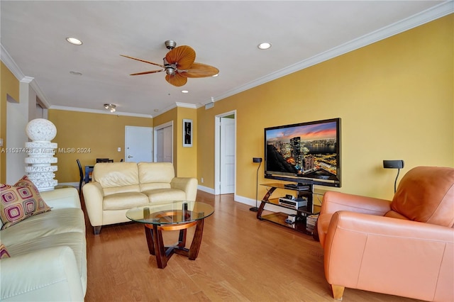 living room featuring ceiling fan, hardwood / wood-style floors, a water view, a wall of windows, and ornamental molding