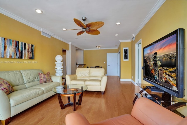 living room with crown molding, ceiling fan, and hardwood / wood-style floors