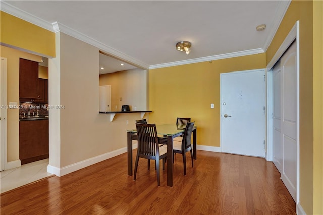 living room featuring a water view, ceiling fan, floor to ceiling windows, ornamental molding, and wood-type flooring