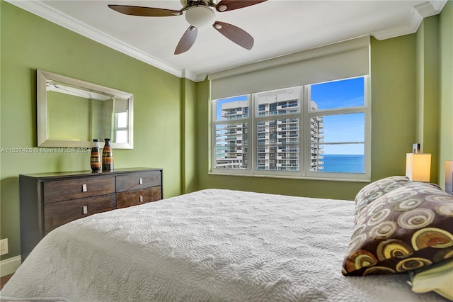 bedroom with ceiling fan, ornamental molding, multiple windows, and light hardwood / wood-style flooring