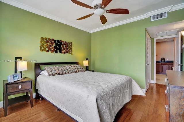 bedroom with ceiling fan, crown molding, and a water view