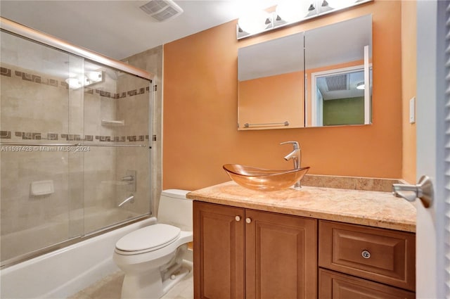 bathroom with tile walls, toilet, tile floors, a shower with door, and vanity