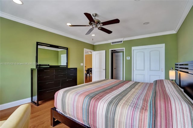 bedroom featuring wood-type flooring, ceiling fan, and crown molding