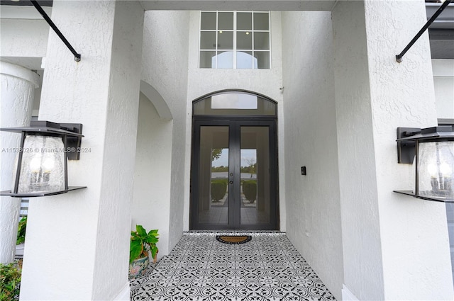 view of exterior entry featuring french doors