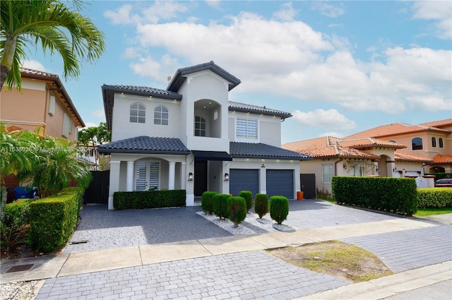 mediterranean / spanish-style home with a garage