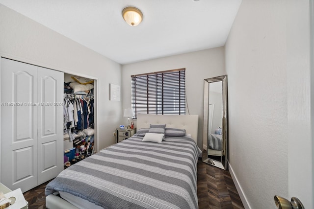 bedroom featuring a closet and dark parquet floors