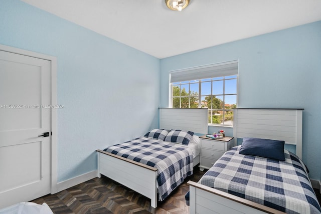 bedroom with dark parquet flooring