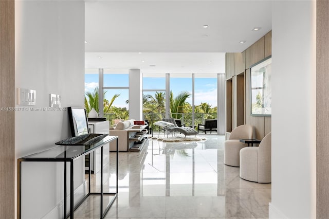 living room featuring expansive windows and light tile floors