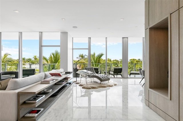 living room featuring floor to ceiling windows and light tile floors