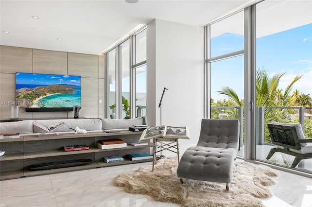 living room with expansive windows, tile flooring, and plenty of natural light