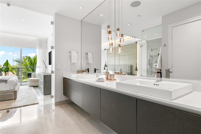 bathroom with tile floors, dual sinks, and vanity with extensive cabinet space