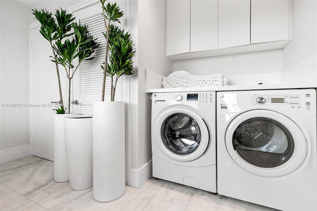 laundry area with cabinets and independent washer and dryer