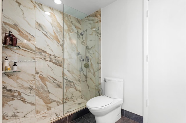 bathroom with tile flooring, an enclosed shower, and toilet