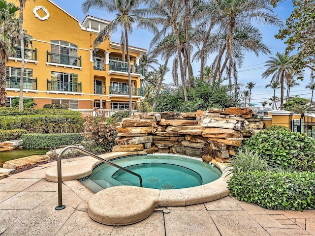 view of swimming pool with a community hot tub