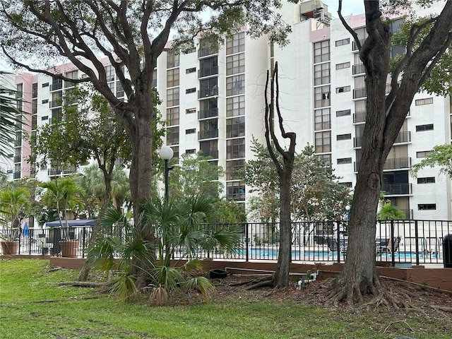 view of building exterior featuring a community pool