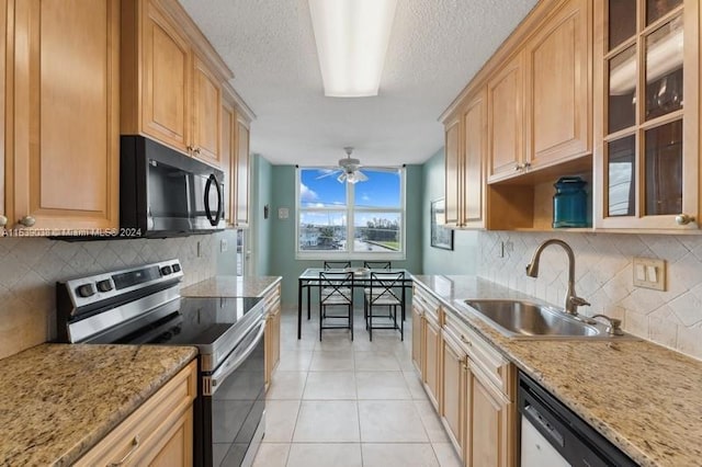 kitchen featuring sink, light stone counters, light tile patterned flooring, ceiling fan, and electric stove