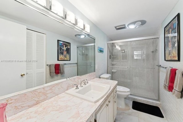 bathroom featuring toilet, an enclosed shower, tile patterned floors, and vanity