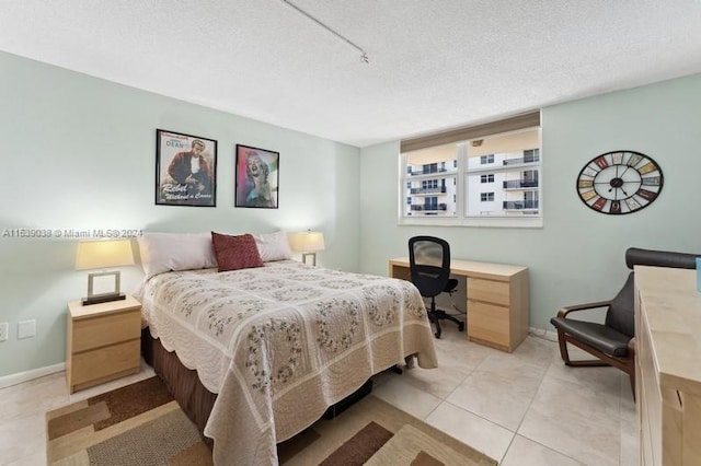 tiled bedroom featuring a textured ceiling