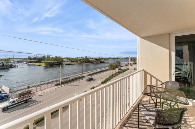 balcony featuring a water view