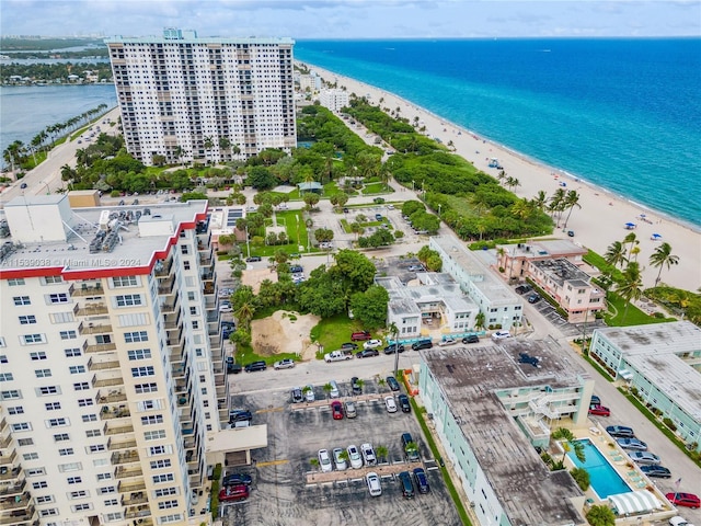 birds eye view of property featuring a beach view and a water view