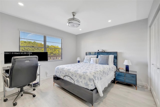 bedroom with a closet and light hardwood / wood-style flooring