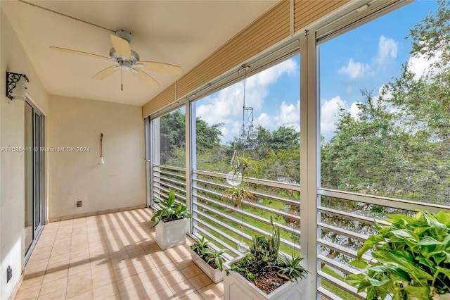 unfurnished sunroom with ceiling fan