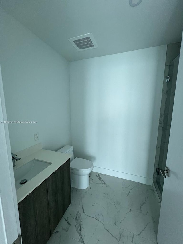 bathroom featuring vanity, tile flooring, a shower, and toilet