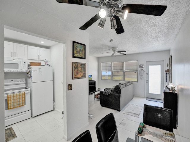 kitchen with white cabinetry, ceiling fan, a textured ceiling, and white appliances