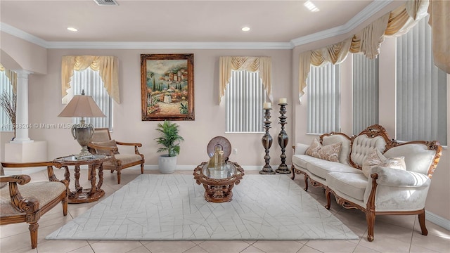 sitting room with light tile floors, decorative columns, and ornamental molding