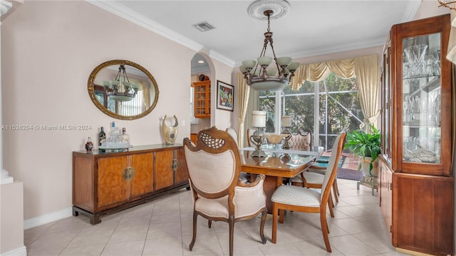 tiled dining room with a chandelier and crown molding