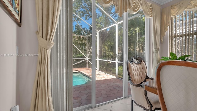 sunroom / solarium featuring a chandelier