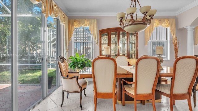 sunroom / solarium with decorative columns, a chandelier, and a wealth of natural light