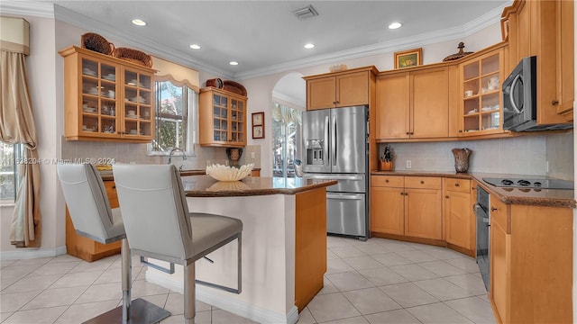 kitchen featuring backsplash, black appliances, light tile flooring, dark stone counters, and ornamental molding