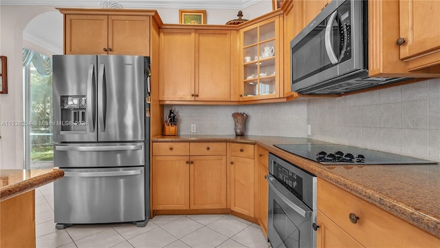 kitchen with ornamental molding, light stone countertops, tasteful backsplash, and stainless steel appliances