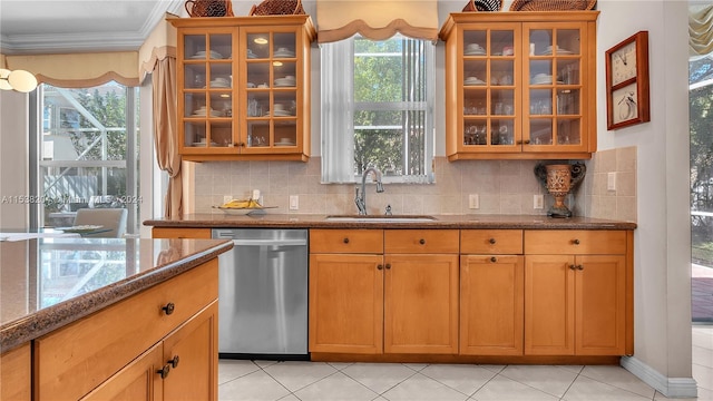 kitchen with backsplash, plenty of natural light, dishwasher, and light stone counters