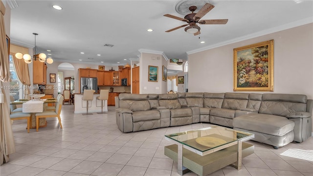 living room featuring ornamental molding, ceiling fan with notable chandelier, and light tile floors