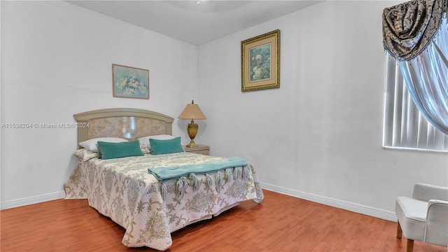 bedroom with wood-type flooring