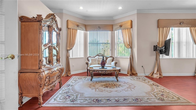 sitting room with ornamental molding and dark hardwood / wood-style flooring