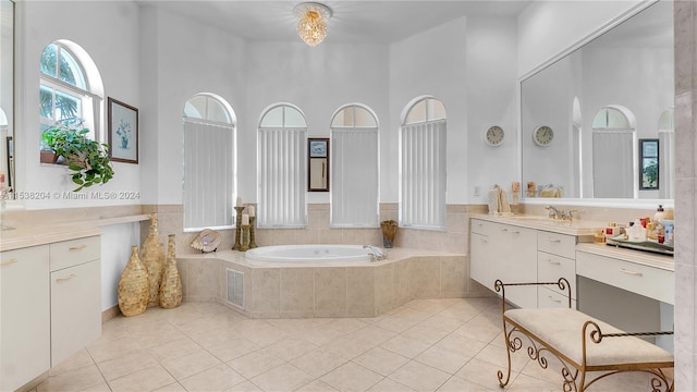 bathroom featuring tiled bath, tile flooring, vanity, and a high ceiling