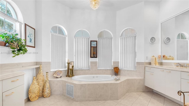 bathroom with tile floors, a relaxing tiled bath, large vanity, and a towering ceiling