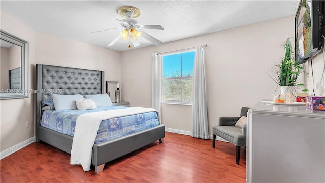 bedroom with ceiling fan and dark wood-type flooring