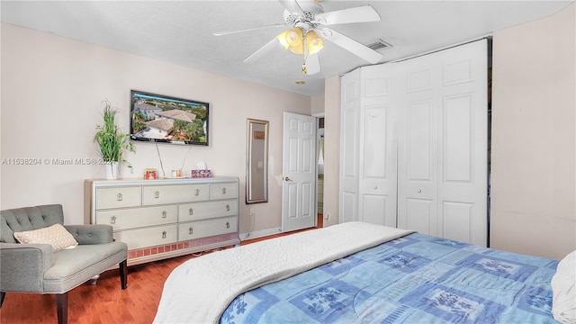 bedroom featuring a closet, wood-type flooring, and ceiling fan