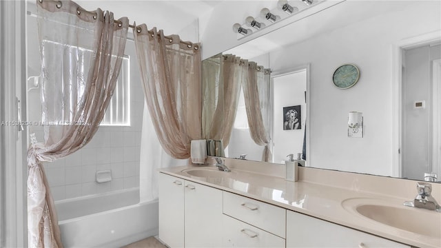 bathroom featuring double sink vanity and shower / bath combo