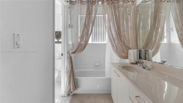 full bathroom with shower / tub combo, vanity, tile floors, and toilet