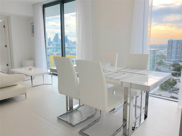 tiled dining space with floor to ceiling windows